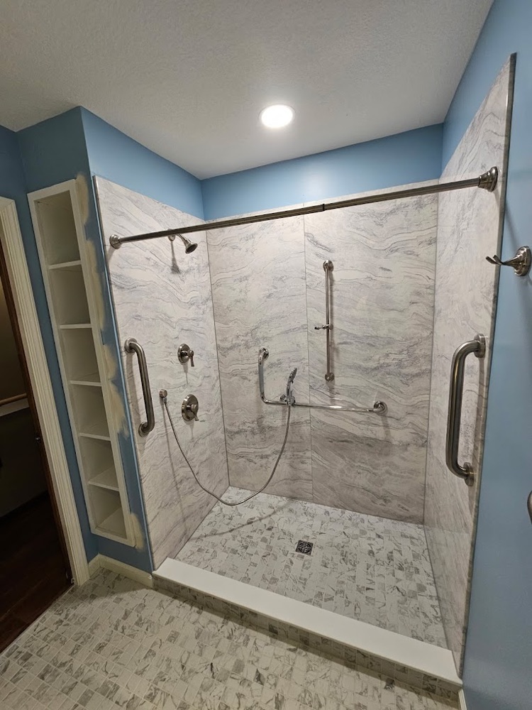 Accessible walk-in shower with grab bars and handheld sprayer
